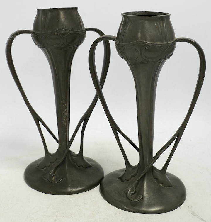 A pair of Art Nouveau Liberty Tudric pewter twin-handled vases, stamped to the bases, 25cm high. Condition - one good, the other poor to fair